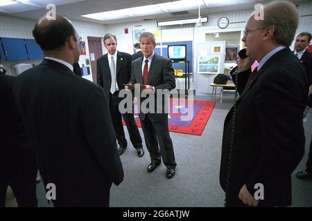 President George W. Bush consults with senior staff Tuesday, Sept. 11, 2001, at Emma E Booker Elementary School in Sarasota, Fla.  Senior staff include, from left: Ari Fleischer, Press Secretary; Dan Bartlett, Deputy Assistant to the President, and Karl Rove, Senior Adviser. Photo by Eric Draper, The White House. Stock Photo