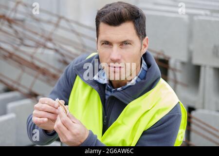 a worker rolls a cigarette Stock Photo