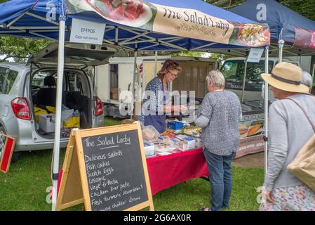 Customer queue at "The Salad Lady" stall at a Farmers market at Katikati. Stock Photo