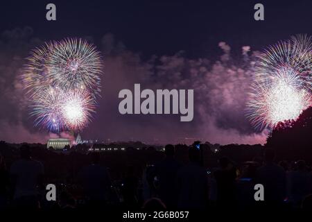 Arlington, United States. 04th July, 2021. Fireworks go off over the National Mall as people celebrate America's 245th Independence Day in Arlington, VA, on Sunday, July 4, 2021. Large crowds gathered on the National Mall and surrounding areas to celebrate the holiday. Photo by Tasos Katopodis/UPI Credit: UPI/Alamy Live News Stock Photo