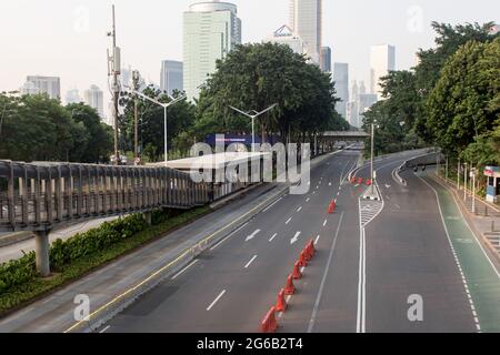 A view of an empty street during the imposition of the emergency restrictions. † Indonesia has imposed emergency community activity restrictions, locally known as PPKM, in Java and Bali from July 3-20 to curb the country's Covid-19 outbreak after the previous policy of micro PPKM proved ineffective. The Health Ministry said on Saturday that Indonesia recorded 27, 913 newly-confirmed cases of Covid-19 in the past 24 hours, the highest daily spike, bringing the total tally to 2, 256, 851, since the first case was detected in March 2020. (Photo by Agung Fatma Putra/SOPA Images/Sipa USA) Stock Photo