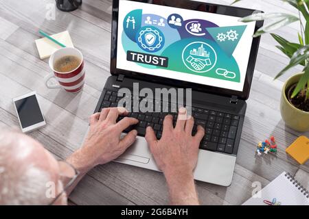 Trust concept shown on a laptop used by a man Stock Photo