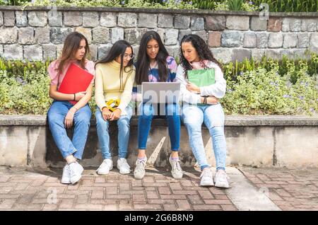 Group of Latina teen student girls working on a laptop. Education and technology concept Stock Photo