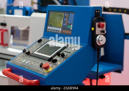 CNC machine operator control panel and CNC pendant. Selective focus. Stock Photo