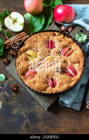 Apple baking gluten free seasonal. Autumn pie with apples, hazelnut and cinnamon on a wooden table. Copy space. Stock Photo