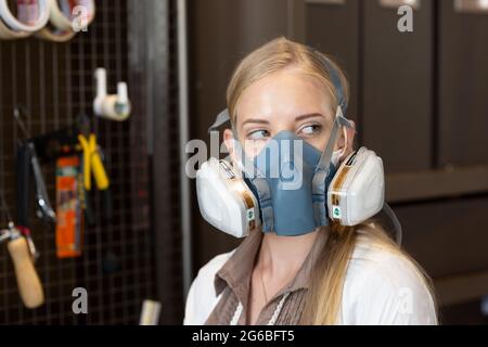 Female engineer or technician is working, examining or repairing automatic robot equipment hardware in the lab or laboratory to upgrade processor chip Stock Photo