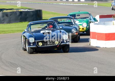 Classic, vintage racing cars competing in the RAC Tourist Trophy at the Goodwood Revival historic event, UK, for 1960s Grand Tourers. Ferrari 250 GT Stock Photo