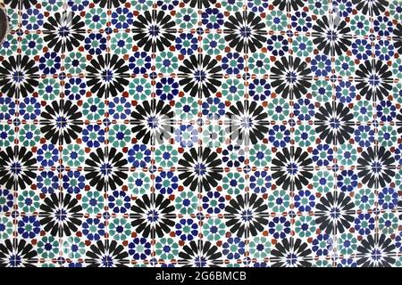 Glazed blue, black, green and red ceramic tiles or azulejos which cover many buildings in Lisbon, Portugal. Portuguese tiles with different designs. Stock Photo