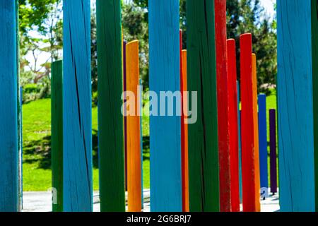 Multicolored wooden poles in a summer park close-up. Stock Photo