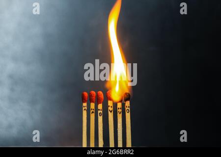Group of a red match burning isolated with the background. Row burning matchstick in the chain reaction. Matchstick art photography. Stock Photo