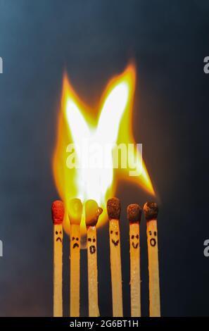Group of a red match burning isolated with the background. Row burning matchstick in the chain reaction. Matchstick art photography. Stock Photo