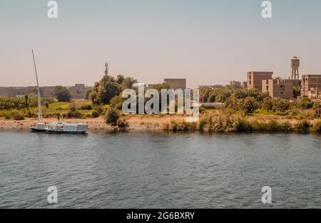 Panoramic view of houses in a traditional village at sunset on the Nile River near Edfu, Egypt Stock Photo