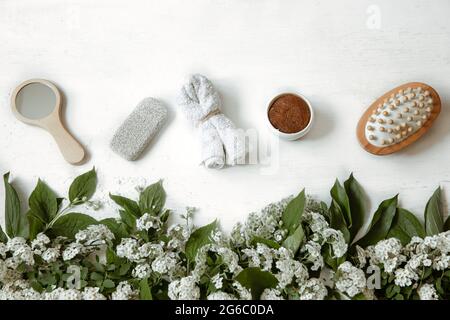 Spa flat lay composition with bath accessories, health and beauty products with fresh flowers. Stock Photo