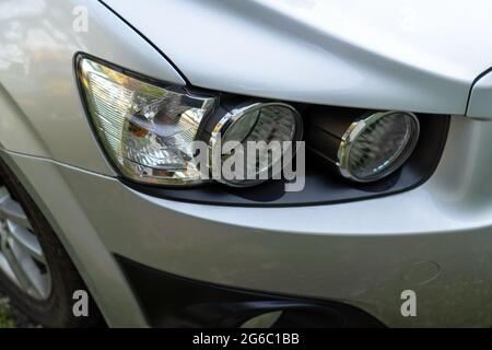 Car headlight on a gray car close-up Stock Photo