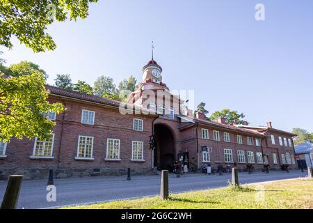 The clock tower building in Fiskars village, a historical ironworks area and popular travel destination. Stock Photo