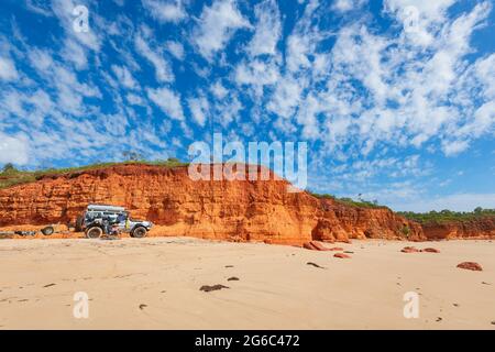 4WD beach driving vehicle with a woman sat in a chair, Pender Bay Escape, Dampier Peninsula, Western Australia, WA, Australia Stock Photo