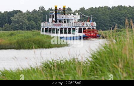 Prerow, Germany. 05th July, 2021. The excursion ship 'Baltic Star' has set off on a round trip across the Prerow Current to the Bodden. The holiday season brings many guests to the Baltic peninsula Fischland-Darß-Zingst. Credit: Bernd Wüstneck/dpa-Zentralbild/ZB/dpa/Alamy Live News Stock Photo