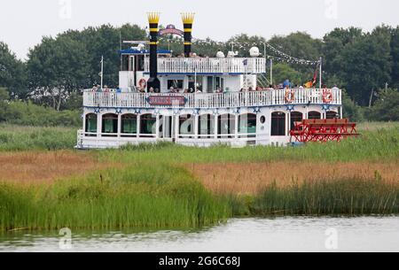 Prerow, Germany. 05th July, 2021. The excursion ship 'Baltic Star' has set off on a round trip across the Prerow Current to the Bodden. The holiday season brings many guests to the Baltic peninsula Fischland-Darß-Zingst. Credit: Bernd Wüstneck/dpa-Zentralbild/ZB/dpa/Alamy Live News Stock Photo