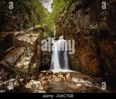 Dramatic Scale Force Waterfall Photo.  Situated close to Buttermere Village, lying part way up Scale Fell near the banks of Crummock Water.  It is reg Stock Photo