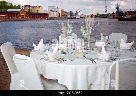 Festively Set Table At The Quay Of The Port Of Lübeck, Mirror Image In A Shop Window, Old Port Of Lübeck Stock Photo