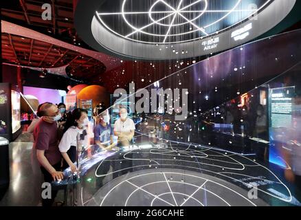 Shanghai. 5th July, 2021. Visitors look at exhibits in Shanghai Astronomy Museum during a media preview in east China's Shanghai, July 5, 2021. The Shanghai Astronomy Museum, the world's largest planetarium in terms of building scale, will open on July 17, the planetarium announced Monday. The museum is located in the China (Shanghai) Pilot Free Trade Zone Lingang Special Area. It is a branch of the Shanghai Science and Technology Museum. Credit: Fang Zhe/Xinhua/Alamy Live News Stock Photo