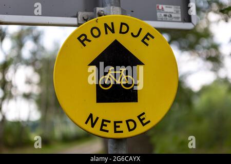 WIERDEN, NETHERLANDS - Sep 10, 2020: Round yellow bike route sign. Translation ROUTE AROUND NEEDE Stock Photo