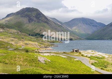 Landscape photo of Wast Water in the Lake District Natinal Park with Great Gable Moutain in the background and the winding country road over the fells Stock Photo