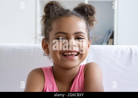 Closeup portrait of happy smiling african american girl child looking at camera Stock Photo