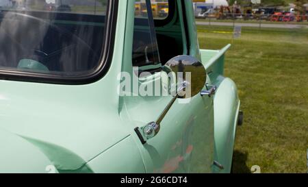 A Side View Mirror on an Old Pickup Truck Stock Photo