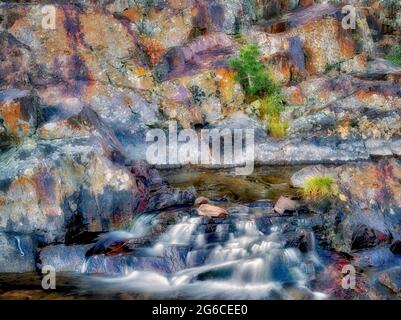 Small waterfal with lichen covered rocks on Glen Alpine Creek near Fallen Leaf Lake. California Stock Photo