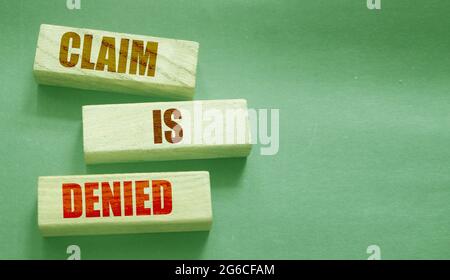 Claim is denied on Wooden Blocks on dark grey background with copyspace. The answer is No. Business financing sponsorship concept. Stock Photo