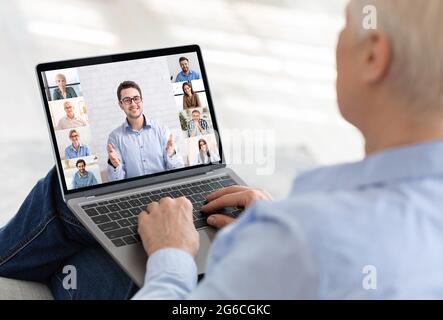 Online Training. Senior Woman Having Web Conference With Group Of People And Teacher Stock Photo