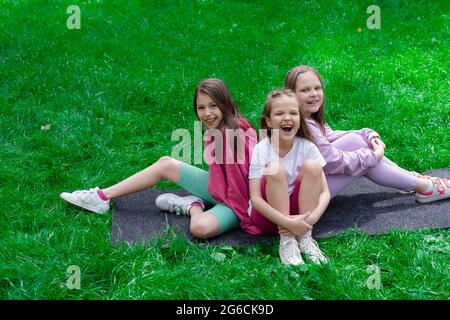 three-pretty-tween-girls-laughing-together-outdoors-in-fall-colors