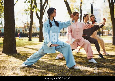 Students repeating parting the wild horse mane form after teacher Stock Photo