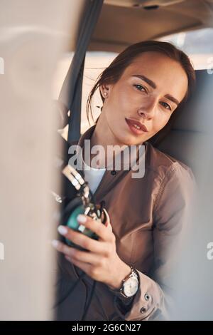 Charming young woman sitting in aircraft pilot cabin Stock Photo