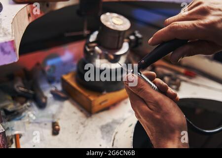 Jewelry maker installing new burr to drill device Stock Photo