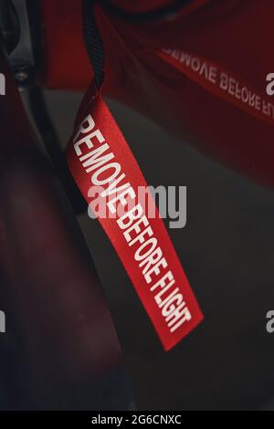 Remove before flight label on red aircraft Stock Photo