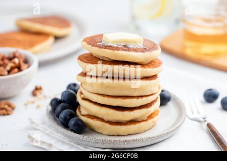 Breakfast pancakes with butter and blueberries on white plate. American cuisine food Stock Photo