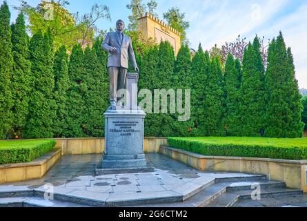 KYIV, UKRAINE - MAY 18, 2021: The monument to Heydar Aliyev in park with lush thuja trees in background, on May 18 in Kyiv Stock Photo