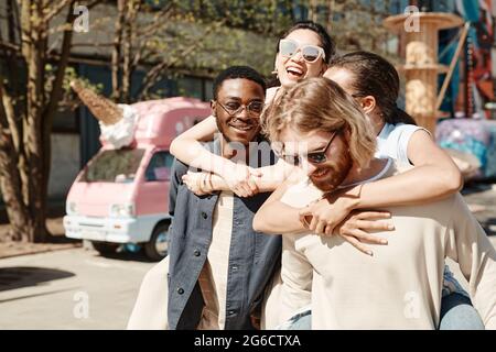Waist up portrait of carefree young people in Summer city Stock Photo