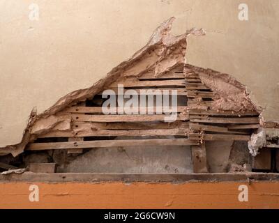 Detail of old lath and plaster wall in abandoned derelict building. Stock Photo