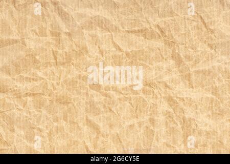 Crumpled Kraft paper texture background. Light brown color Stock Photo
