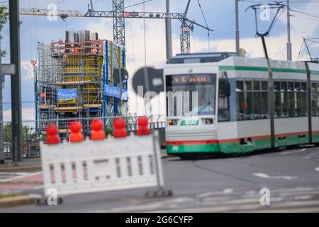 Magdeburg, Germany. 05th July, 2021. A tram passes a barrier at the major construction site of the new power bridge train. In the state capital, road traffic has now been closed to traffic for an area in front of the construction site because of the construction work. In several construction phases, further areas around the major construction site are to be closed off by the end of 2023. Credit: Klaus-Dietmar Gabbert/dpa-Zentralbild/ZB/dpa/Alamy Live News Stock Photo