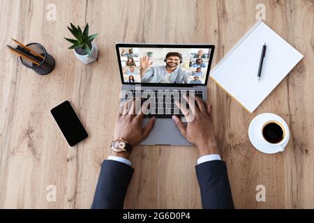 Unrecognizable Black Businessman Having Video Call On Laptop With Multiethnic Colleagues Stock Photo