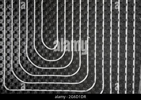 High angle of radiant heating systems with pipes installed on floor in contemporary wooden cottage Stock Photo