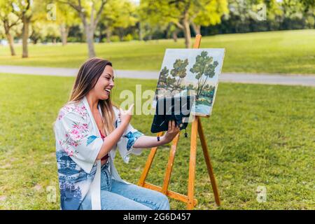 Artist making a video call to show her work Stock Photo