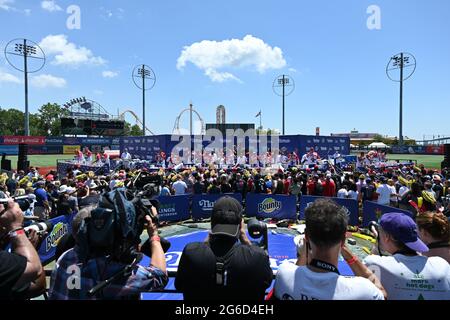 Joey Chestnut and competitors at the Nathan's Famous Fourth of July International Hot Dog Eating Contest in New York. 4 Jul 2021 Stock Photo