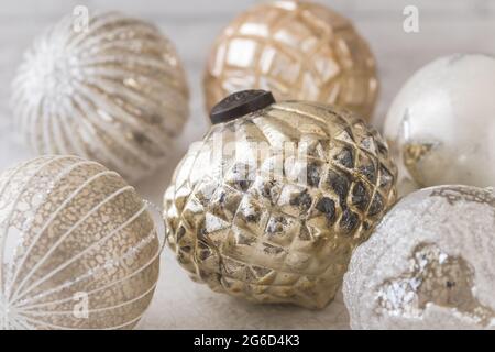 Gold and silver shimmering structured christmas baubles on a white background Stock Photo
