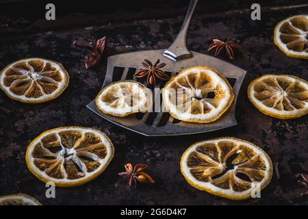 Dried lemons and oranges slices on an old baking sheet. Used for christmas decoration. Stock Photo