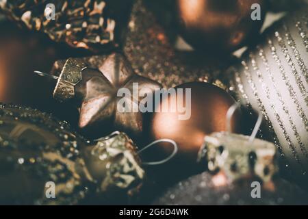 Closeup of decoration for the christmas tree in harmonian dark bronze, golden and silver colors, selective focus on a star Stock Photo